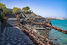 a beautiful stone bridge by the ocean