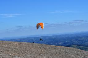a man parachuting into the ocean