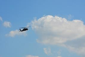 helicopter flying in the sunny sky