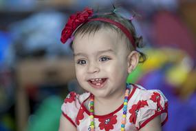 portrait of a little girl in red on a blurred background