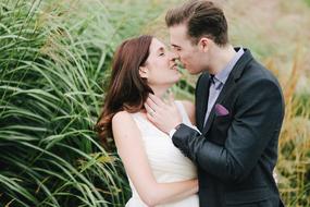 wedding couple kissing at tall grass