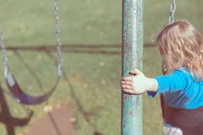child and Swing on Playground
