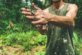 a photo of dirt on a man's hands