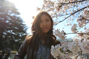 portrait of the asian girl and white flower tree