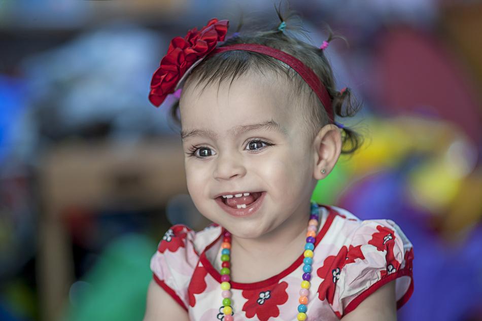 portrait of a little girl in red on a blurred background