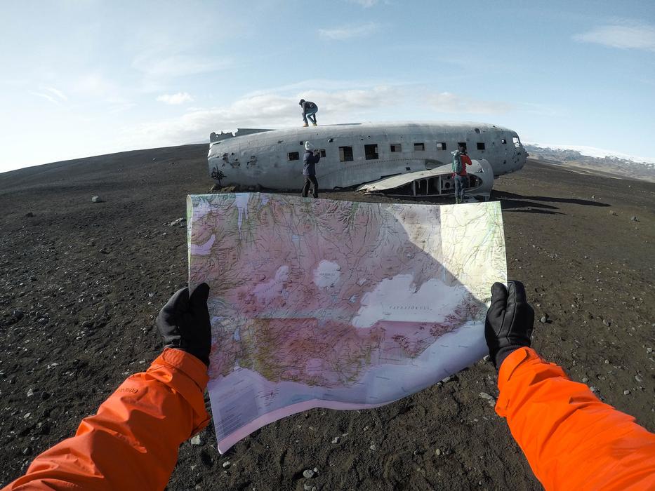 map in hands in front of lapsed Airplane