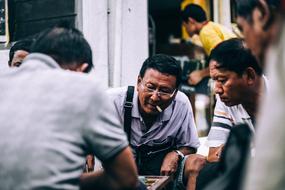 asian Men group playing table game