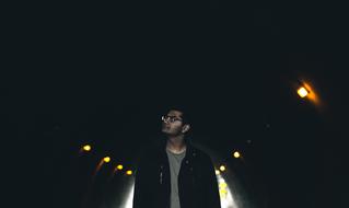 man in a dark tunnel with lanterns