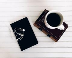 hot coffee with the phone on the table