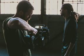 man with a video camera in production