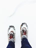 man's feet in the snow