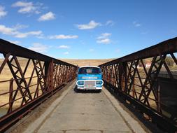 blue car on the bridge