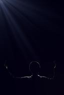 Person, in the beautiful lowlight, among the darkness