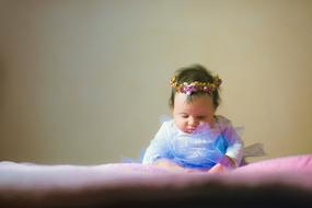 baby in a flower wreath