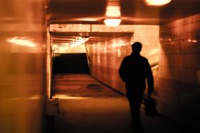 Alone Man walks away in underground tunnel