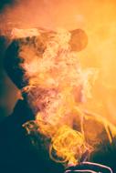 silhouette of a man in yellow smoke