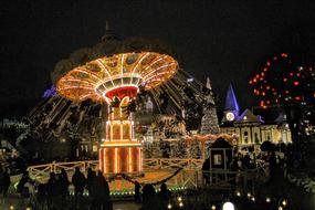 people at night amusement park at christmas