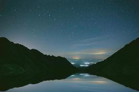 a beautiful starry sky with mountains
