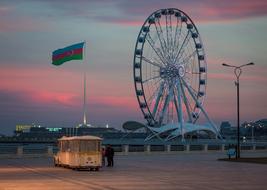 Azerbaijan flag and ferris wheel against the background of the evening sky