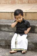 photo of an indian boy with a toy smartphone