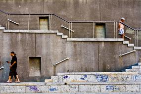 People, walking on the concrete steps, with the colorful drawings