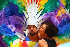 woman kissing Colorful costumed man on Csd Parade, germany, hamburg