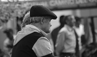 Black And White Portrait of senior Man among blurred people