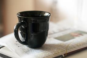 black mug on the paper