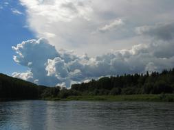 trees with a lake and clouds