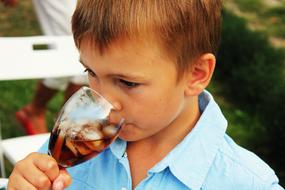 boy with ice drink on blurred background