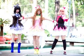 Girl dolls posing in colorful costumes