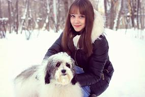 Dog and girl in snowy park