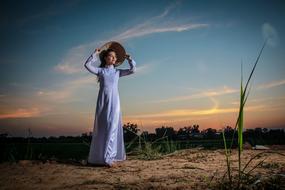 girl in traditional costume at sunset in vietnam