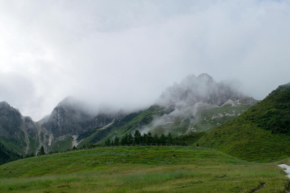 cloudy landscape with green meadow