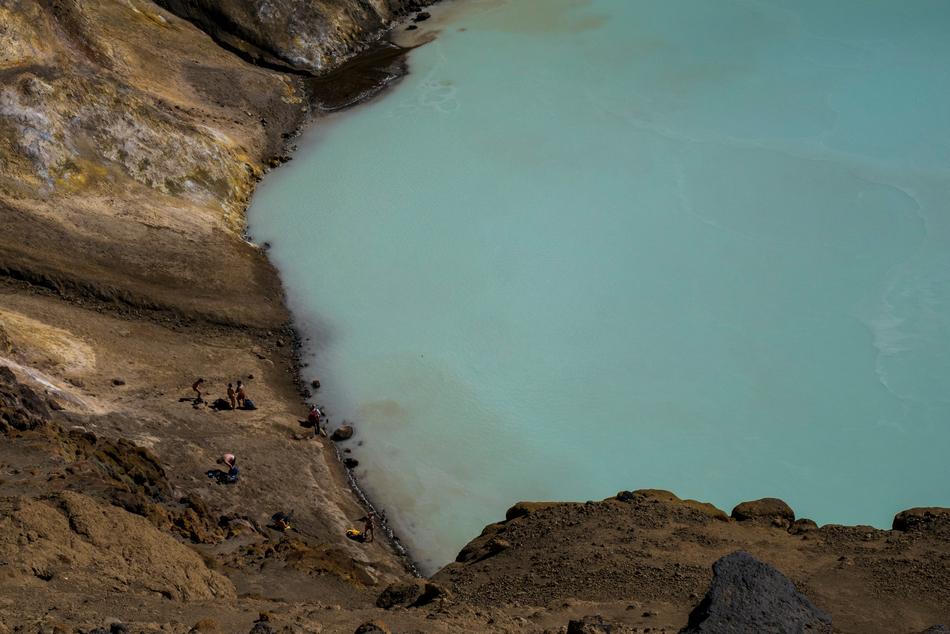 women swim near the coast near the rocks