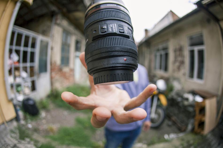 lens in hand close-up on blurred background