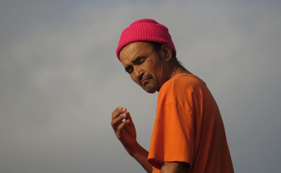 Portrait of the person in orange t-shirt and red hat