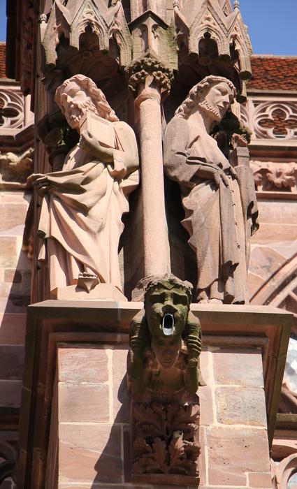 stone sculptures and a gargoyle on the facade of the Cathedral