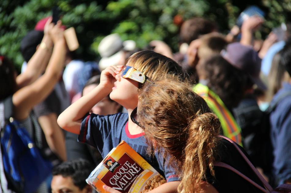 observing eclipse sun in blurred background