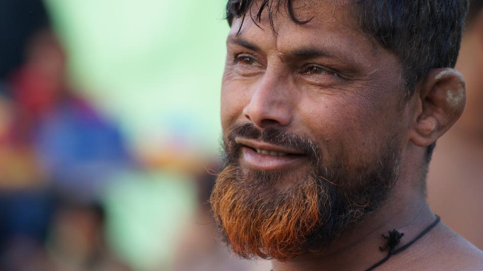 indian with red beard close up on blurred background