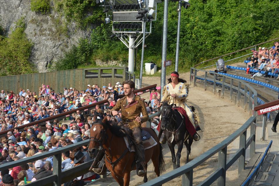horse riders among people in open air theater