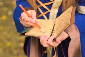 the man writes in his notebook