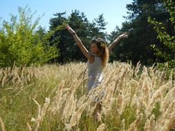 a happy girl in a wheat field