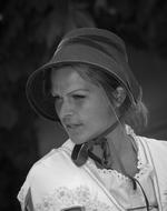 black and white photo of a girl in a hat on a dark background