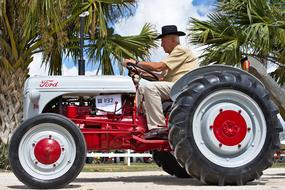 senior man driving Antique Tractor