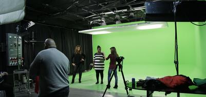 people in the studio on a green background