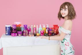 photo of a girl and korean cosmetics on the table