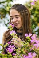 girl posing with flowers on a blurred background