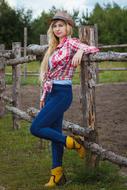 photo of a girl in cowboy clothes at a stable in Russia