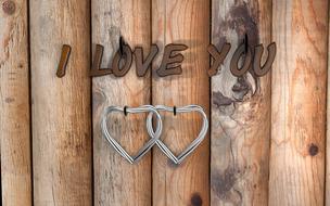 silver hearts in a wooden fence